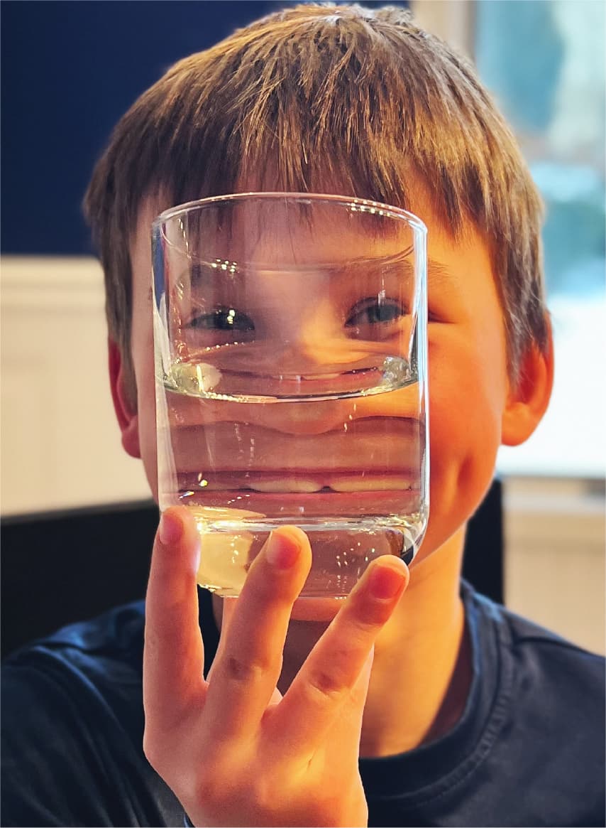 boy raising a glass of water