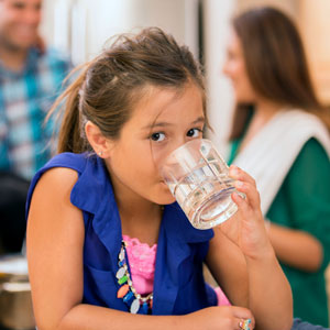 Girl drinking Water from glass.