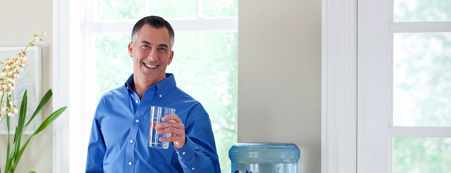 Culligan expert with glass of clean filtered water