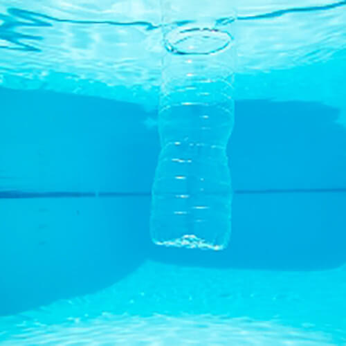 bottle in chlorine water filled swimming pool