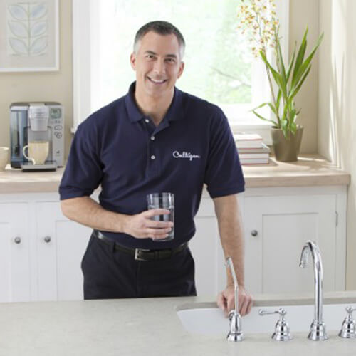 Culligan expert holding a glass of drinking water