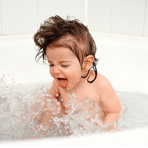 happy baby in clean water bath