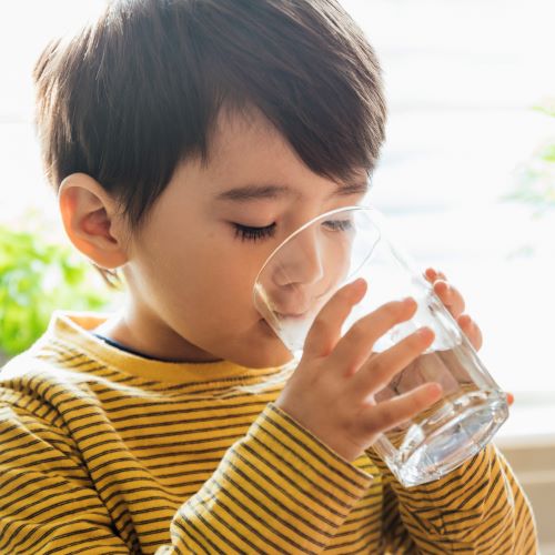 boy drinking water without worrying about chlorine