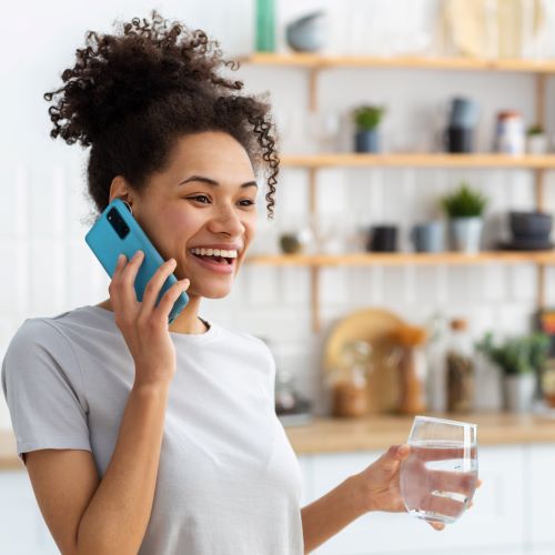 woman on phone with water filtration company