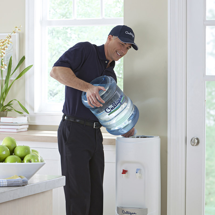 Culligan Expert Replacing a 5 Gallon Bottle on Top of a Water Dispenser