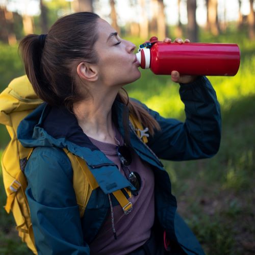 Women stay with Backpack with reusable water bottle in a pocket