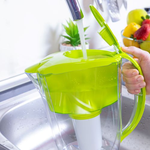 filling water pitcher filter at sink