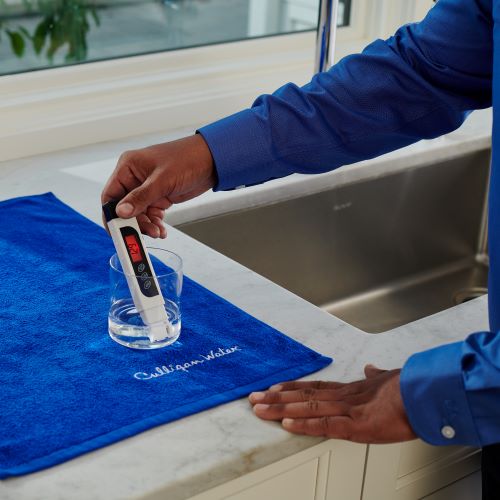 Culligan expert using TDS tester at professional water test