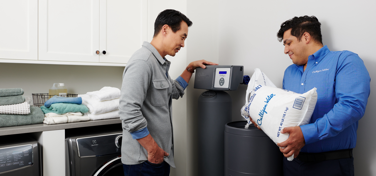 Culligan man refilling a customer's water softener with salt.
