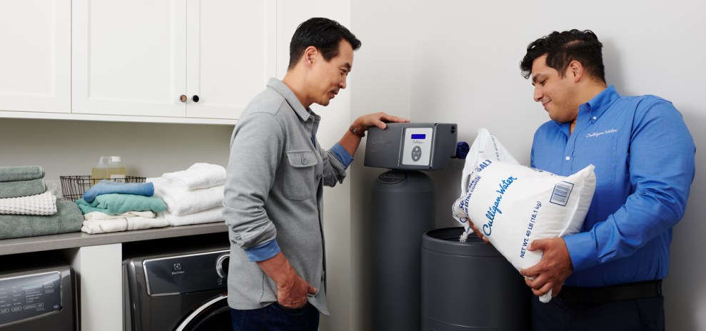 Culligan Expert refilling a customer's water softener with salt.