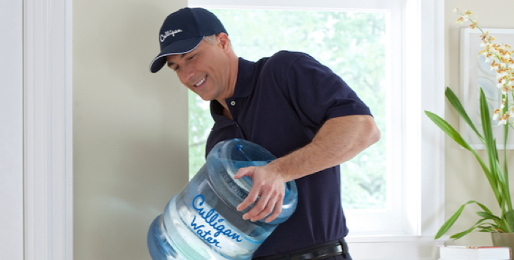 Culligan delivery man replacing a water dispenser jug