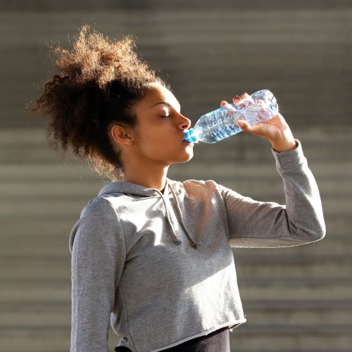 Athlete drinking from a plastic water bottle