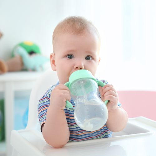 baby drinking water from sippy cup