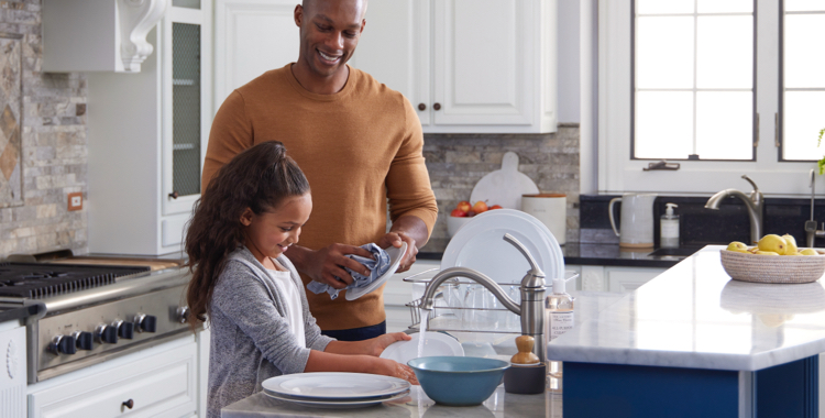 Family washing dishes with clean, filtered water