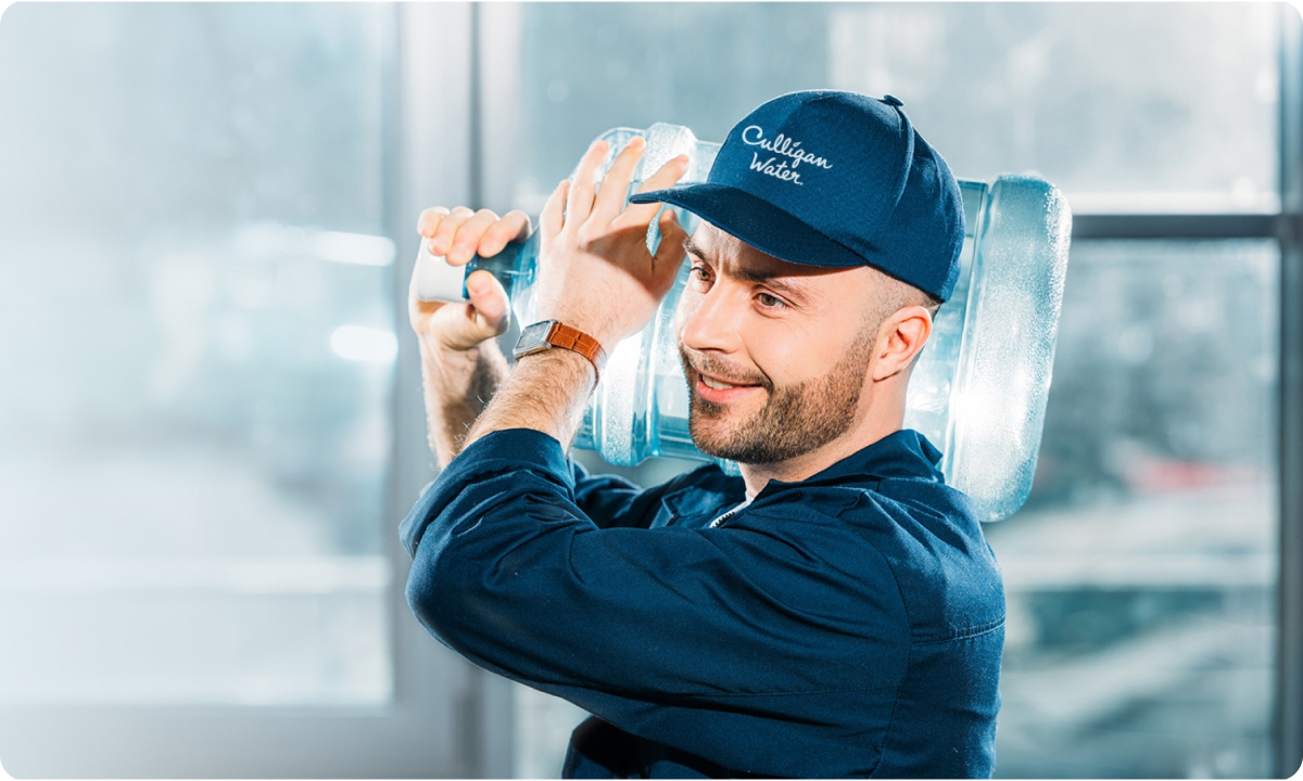 Culligan Expert delivering a 5 gallon water dispenser jug
